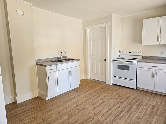Partial view of kitchen with door to storage area at left rear