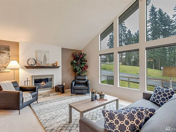 "Clear-story" floor to ceiling windows in the living room allow ample natural light to flow throughout giving this space a grand feel.