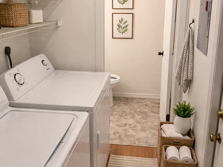 laundry room leading into downstairs half bath - digitally staged