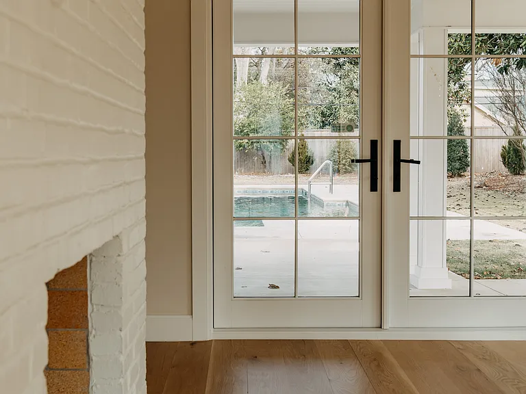 Sunroom/office space with doors to covered porch and pool area