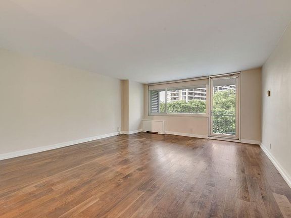 From Front Door to Balcony; lovely walnut wood plank flooring; roller shades on window