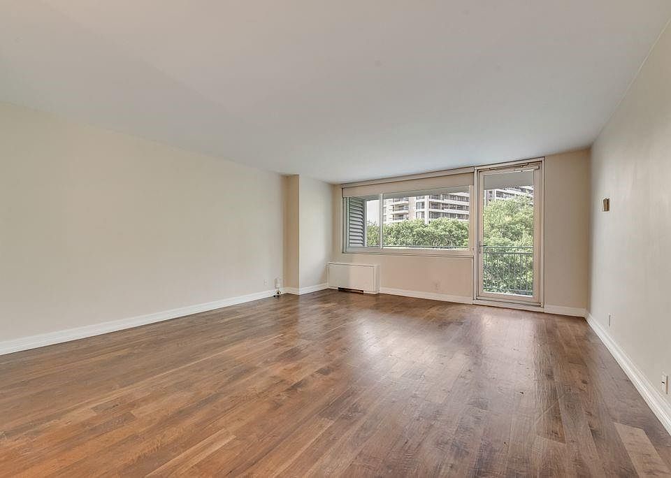 From Front Door to Balcony; lovely walnut wood plank flooring; roller shades on window