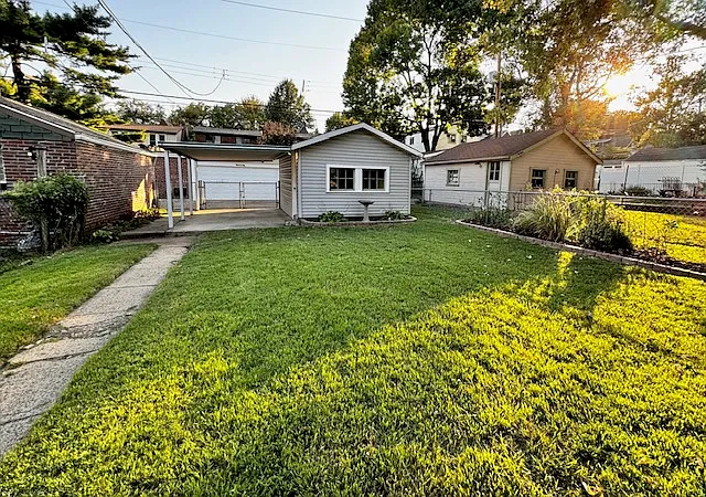 Backyard with one-car garage and covered/fenced carport