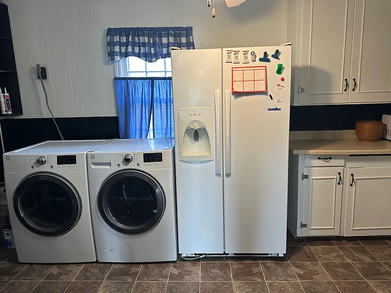kitchen with washer, dryer, refrigerator and stove
