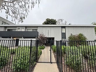 Gated exterior with front gardens