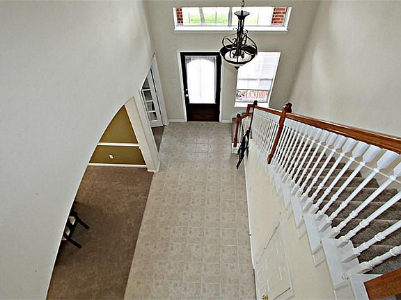 STEP INSIDE TO THE WELCOMING TWO STORY FOYER OF THIS CHARMING HOME GRACED BY A LEAD GLASS FRONT DOOR