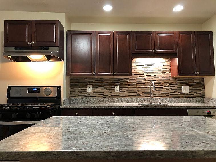 New kitchen with island and recessed lighting