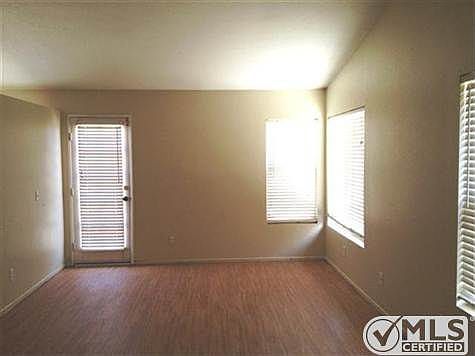 Family Room with windows, plant shelf, door with blinds to b