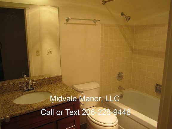 Bathroom with granite countertops and cherry cabinets.