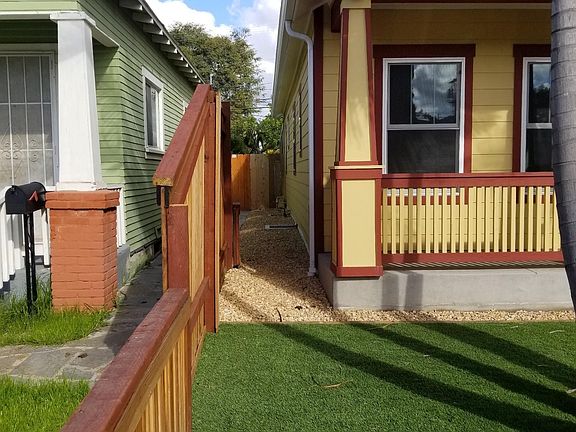 New redwood fence both provides privacy and allows for neighborly conversation with professionals living next door.