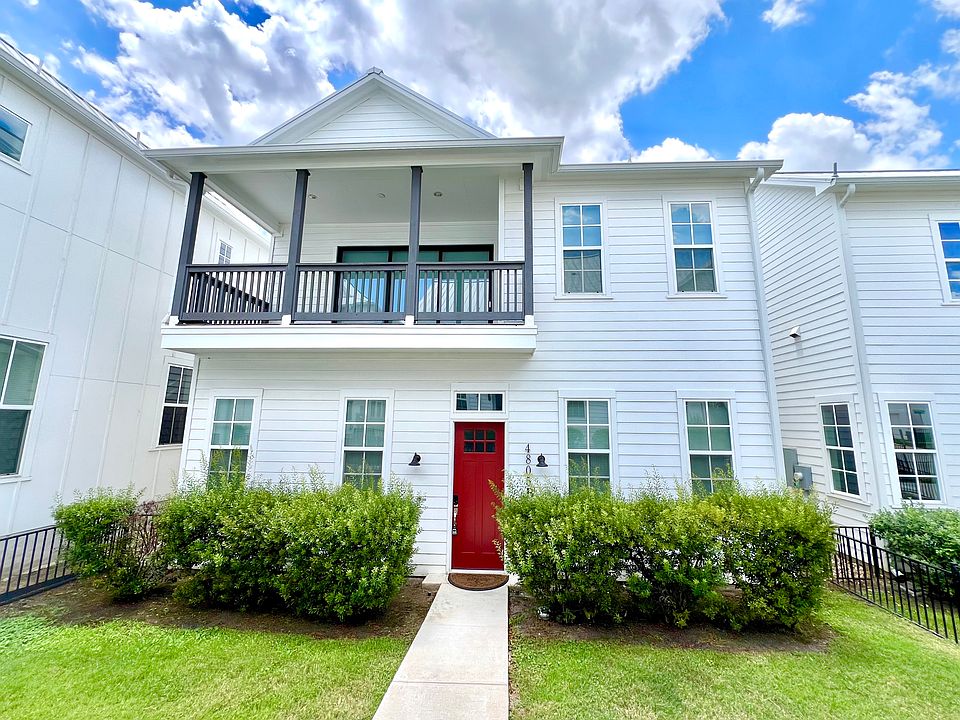 Front of Home with balcony view and front yard.