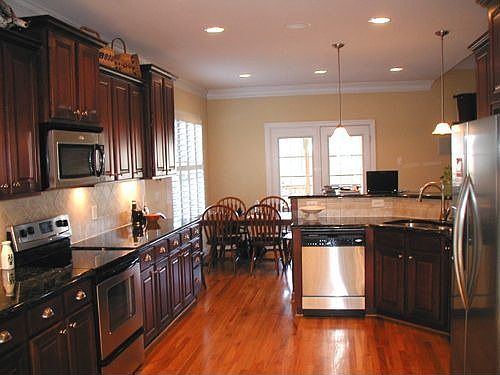 Kitchen has 42" cherry cabinets, stainless appliances, granite counters