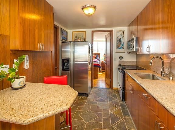 Maple cabinets are also custom-made, and intricate flooring design was hand-laid with slate tiles.