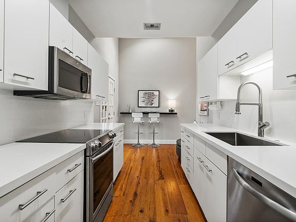 Bright modern kitchen with quartz counter tops and updated appliances