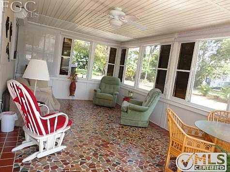 Enclosed Florida room has beautiful windows, and a fabulous tile job!