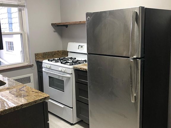 Kitchen with new cabinets, granite counters & flooring.