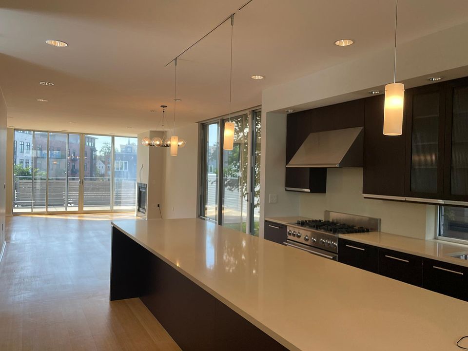Open Concept Kitchen, Dining and Family Room with Attached Deck and Side Yard