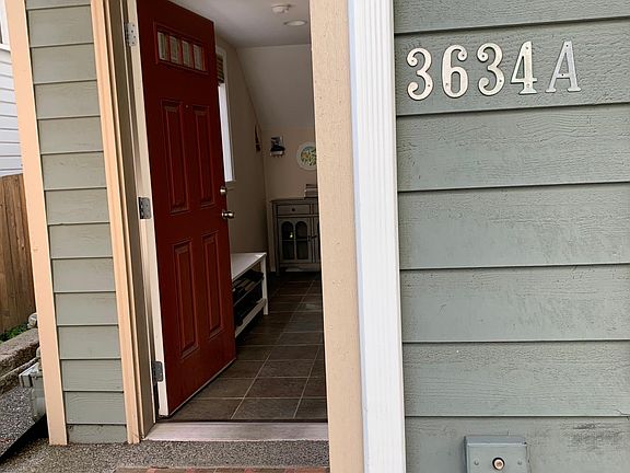 small stoop, front door leads to mud room/foyer