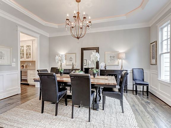 DR w/tray ceiling+cove light, chandelier and rich details