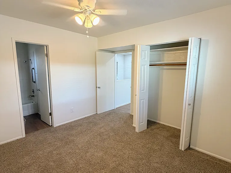 Bedroom view of closet and bathroom