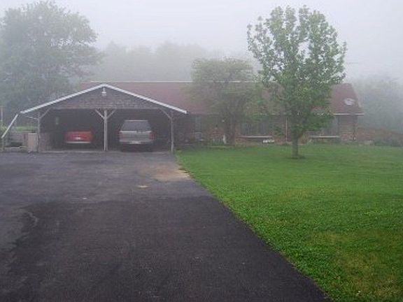 House & driveway on a foggy morning