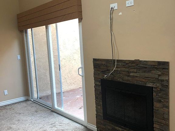 Fireplace and slider to back patio.