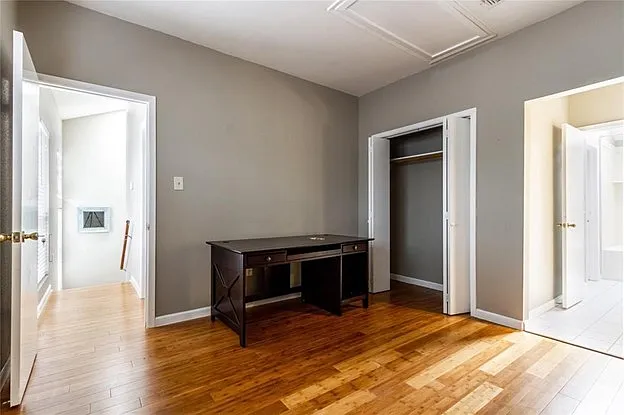2nd floor extra bedroom with wood flooring. Connects to bathroom.