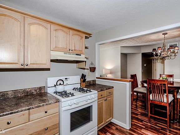 The spacious kitchen offers ample counter-top space and cabinet storage and is open to the dining ar