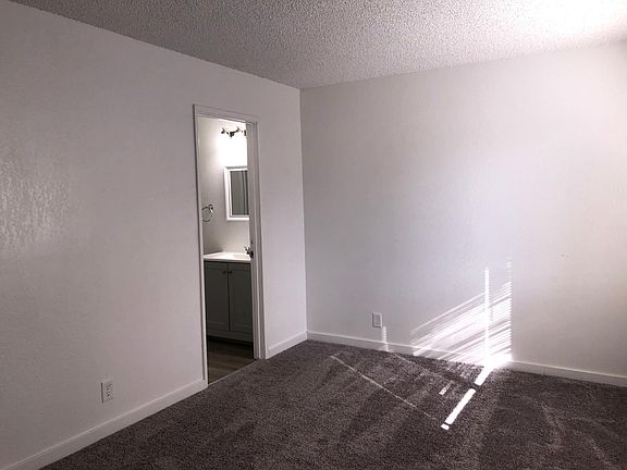 Master bedroom with door to shared bathroom.