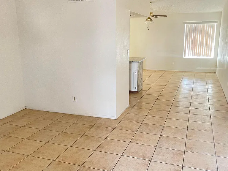 View from front door of Living Room towards back. Does not show new paint or ceilings redone.