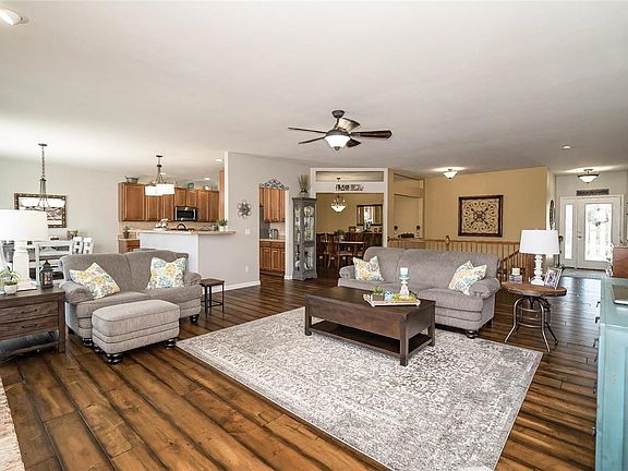 From the fireplace, you can see the openness of the floor plan & get a glimpse of the Breakfast Room on the left, Kitchen in the middle, and Dining Room on the right.