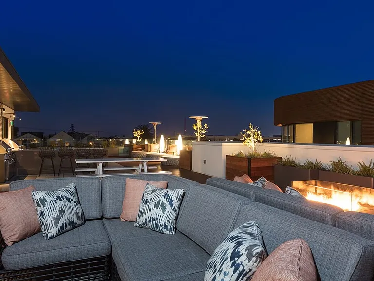 Rooftop deck with fireplaces and common area seating
