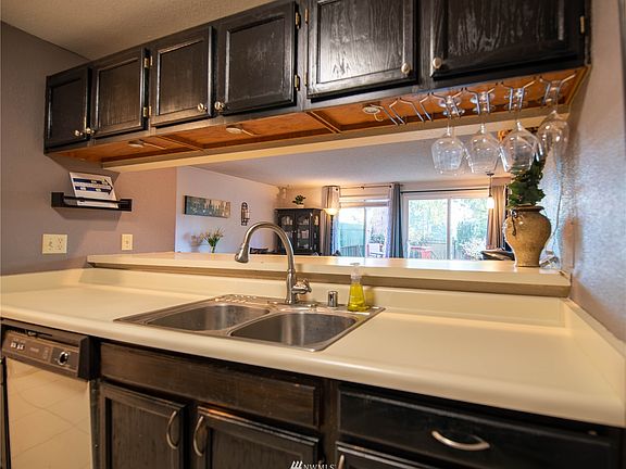 Wine glass rack adjacent to breakfast bar>