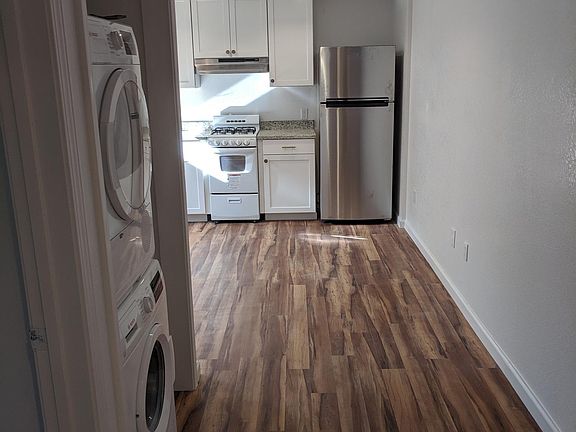 View from bedroom door toward the kitchen. The bathroom door is shown on the left.