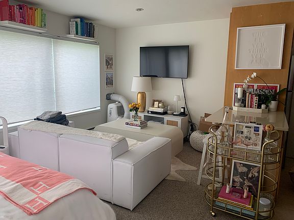 Long view of living area with complete wall of windows to left.