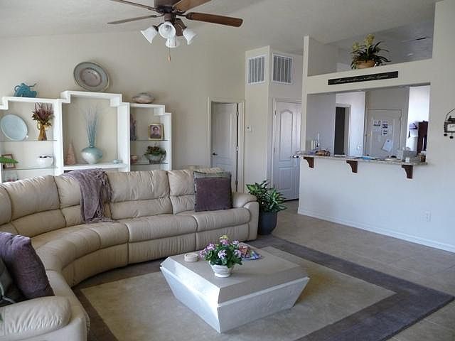 Living room, all tile, looking towards kitchen and owner's suite