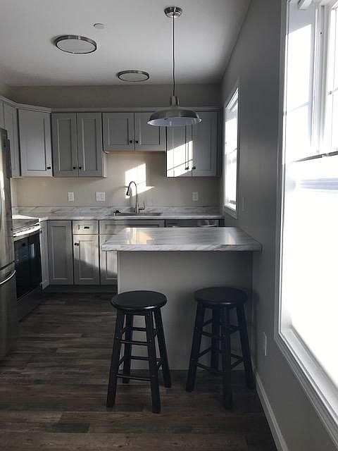 New, energy efficient, fully equipped kitchen including garbage disposal, dishwasher, over range microwave, stove, and French door refrigerator.