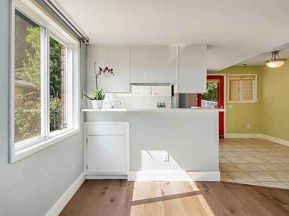 Kitchen bar with dining table space to the right and easy access to the back garden.