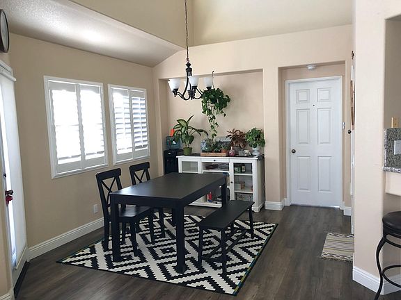 Open space dining room concept adjacent to living room and kitchen. Vaulted ceilings and access to private balcony.