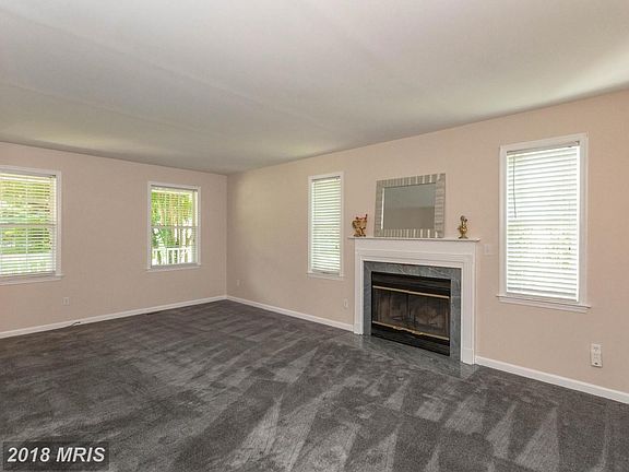 Spacious living room with fireplace, new carpet