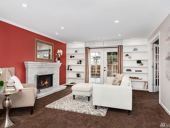 You'll be cozying up to the fireplace with a good book in hand in no time. Southern exposure invites loads of light through the French doors which open onto a deck & fully fenced backyard. Ideal for entertaining, you'll be quick to fire up the grill or simply take in the lush, mature garden flora.