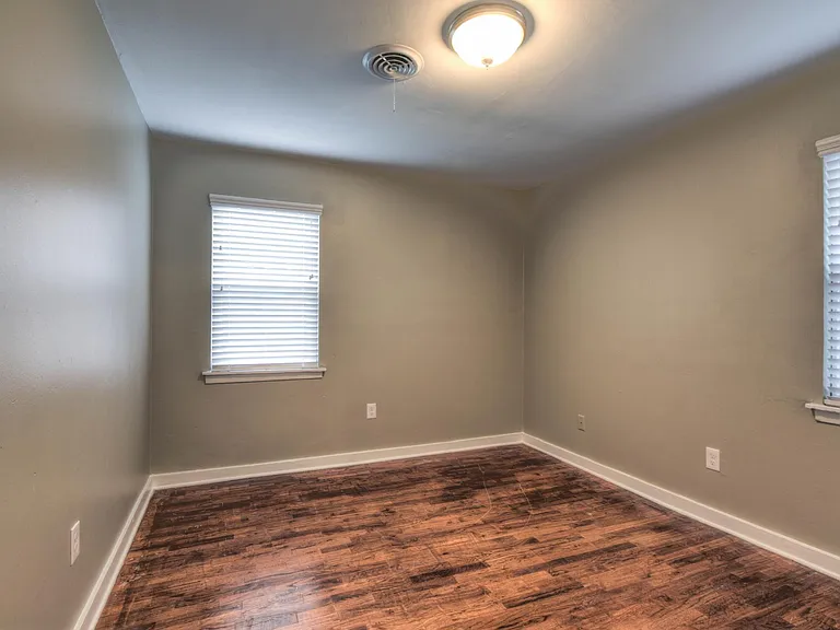 Large 2.5" faux wood blinds cover all windows