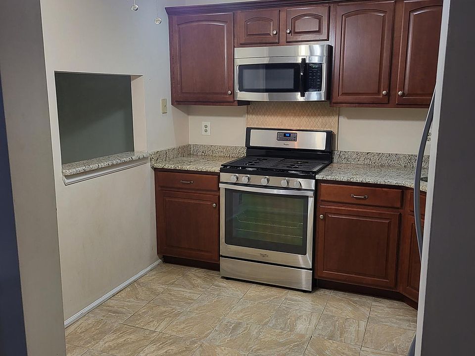 "Modern kitchen with sleek granite countertops and stainless steel appliances."