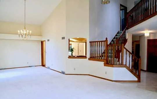 Sitting - Dining areas - empty. Entrance and staircase to the right