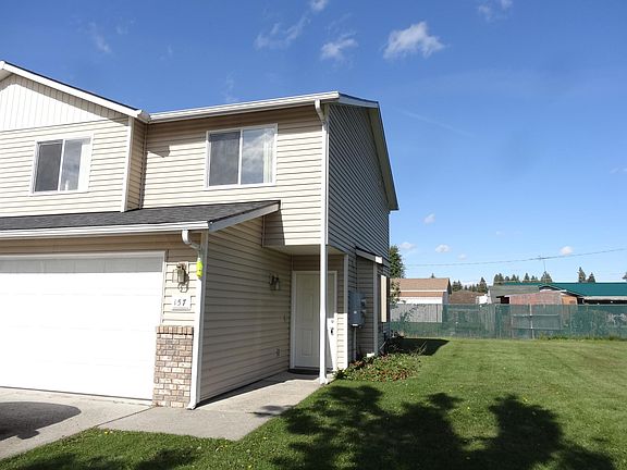 entry and side yard with sprinklers and a strawberry patch