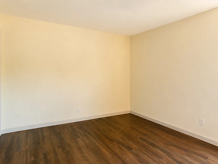 Primary bedroom with a walk-in closet, ceiling fan and ample lighting throughout