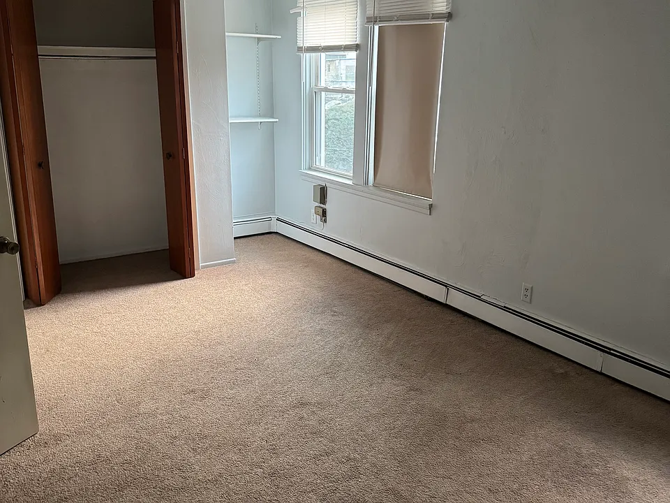 Large Bedroom with plenty of natural light from 4 windows. Deep closet as well as additional shelving.