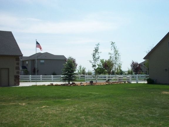 view from the back yard looking at neighbors side yard