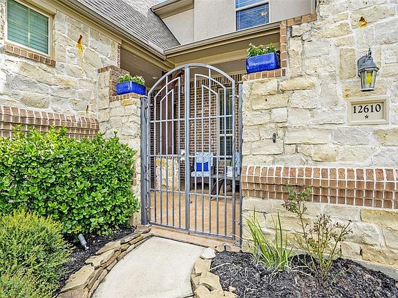 As you enter the home, you first come to a beautiful, bricked, gated courtyard. One of two oft-used outdoor living areas. Sheer elegance.