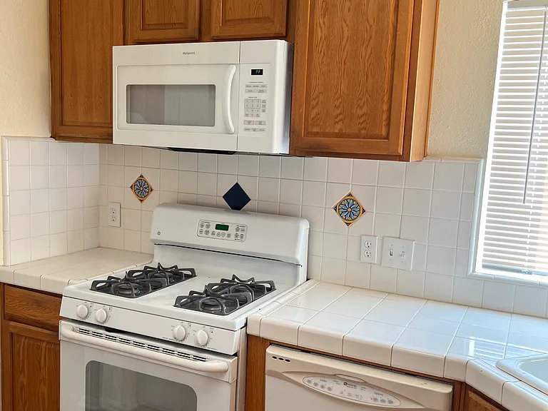 Kitchen w/ Microwave , Stove, and Dishwasher
